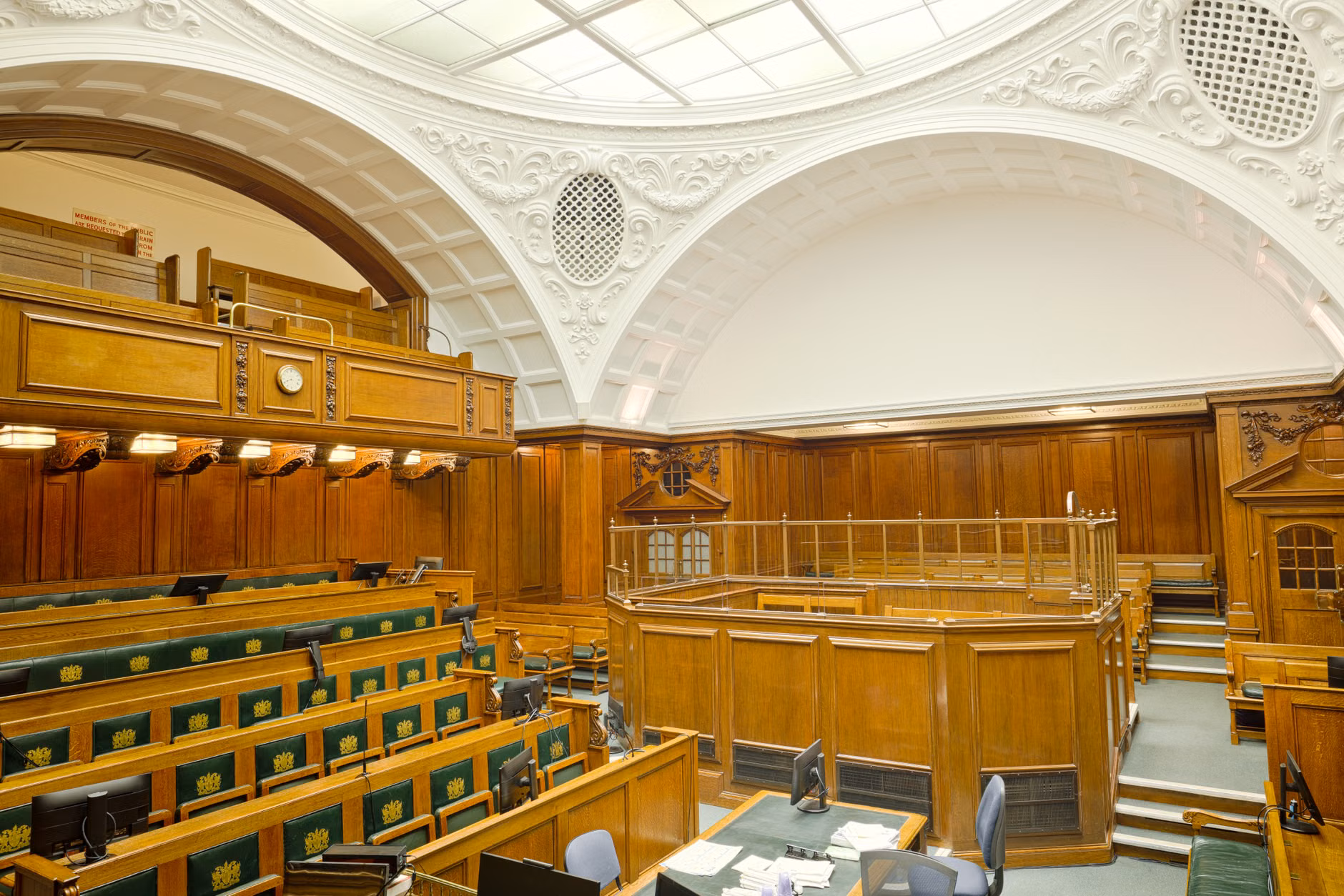 Vista interna di un'antica aula di tribunale a Londra con design decorativo e arredamento in legno.
