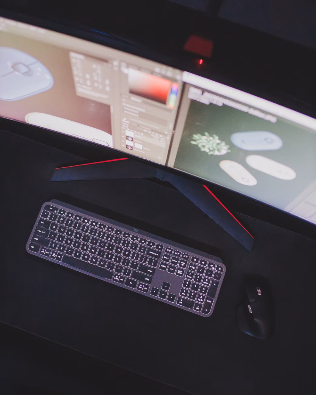 Modern computer setup featuring keyboard, mouse, and curved monitor displaying digital design software.